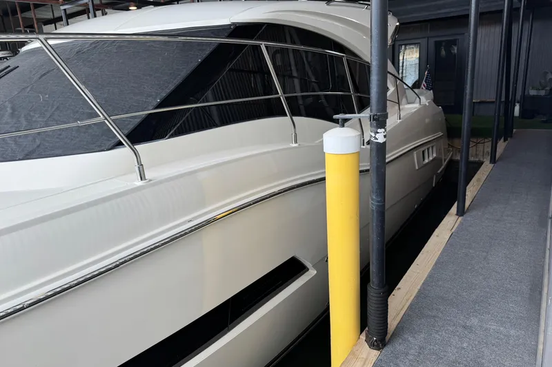 Slide: The Image of 2016 Carver C37 Coupe yacht docked in a marina, side view. - 38