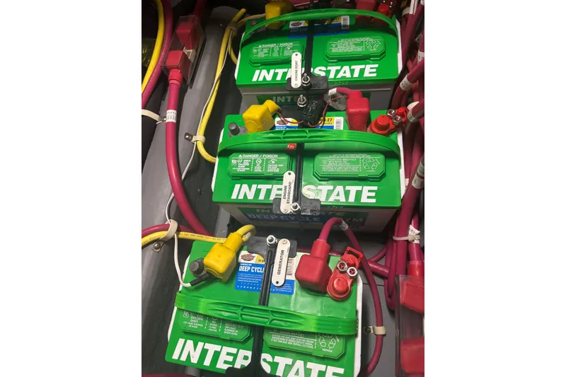 Slide: The Image of Three Interstate deep cycle batteries in a 2016 Carver C37 Coupe engine compartment. - 44
