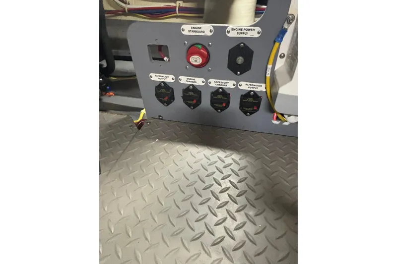 Slide: The Image of Control panel of a 2016 Carver C37 Coupe with labeled switches and diamond plate flooring. - 48