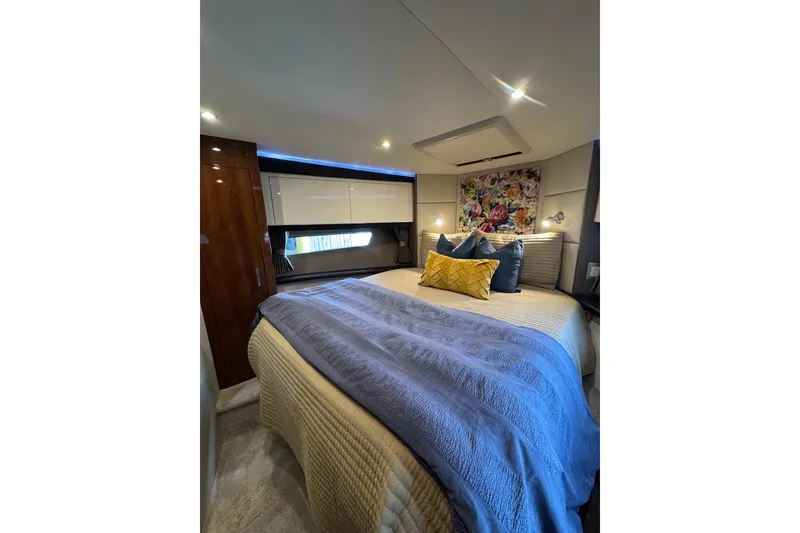 Slide: The Image of Luxurious bedroom interior of 2016 Carver C37 Coupe yacht with elegant bedding and decor. - 50