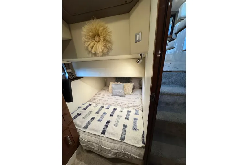 Slide: The Image of Cozy bedroom interior of 2016 Carver C37 Coupe yacht with decorative wall art. - 51