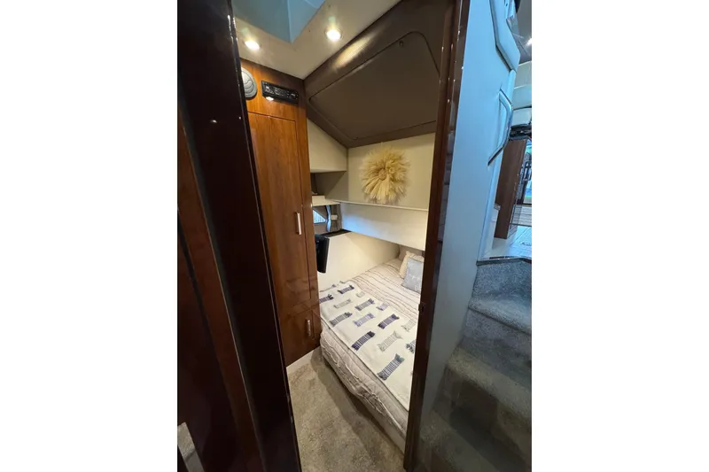 Slide: The Image of Interior cabin of 2016 Carver C37 Coupe with cozy bed and wooden accents. - 52