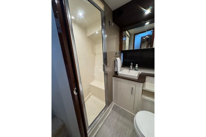 Slide: The Image of Bathroom interior of 2016 Carver C37 Coupe yacht, featuring shower, sink, and toilet. - 55