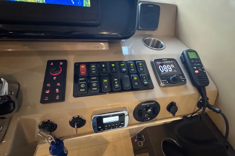 Slide: The Image of Control panel of a 2016 Carver C37 Coupe with navigation and communication equipment. - 59