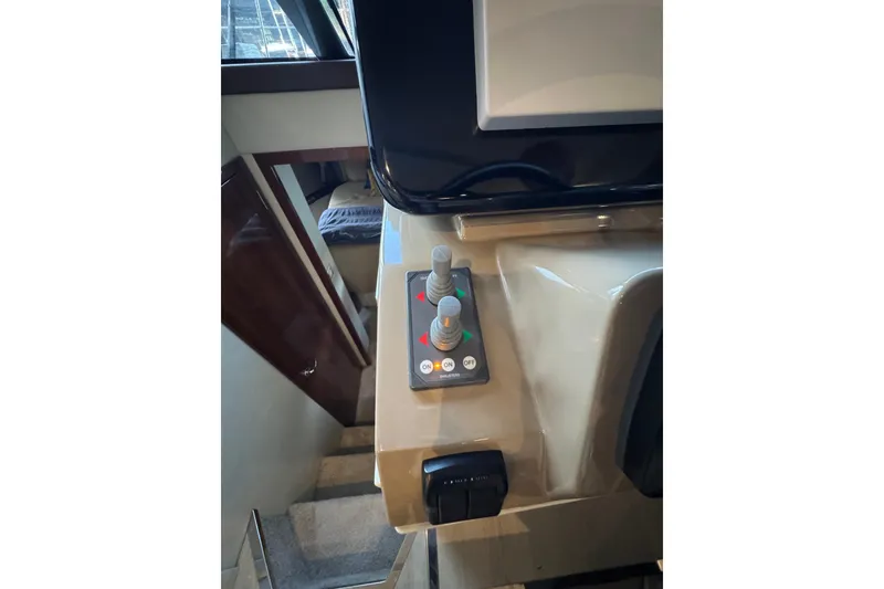 Slide: The Image of Control panel inside 2016 Carver C37 Coupe yacht, featuring switches and knobs. - 63