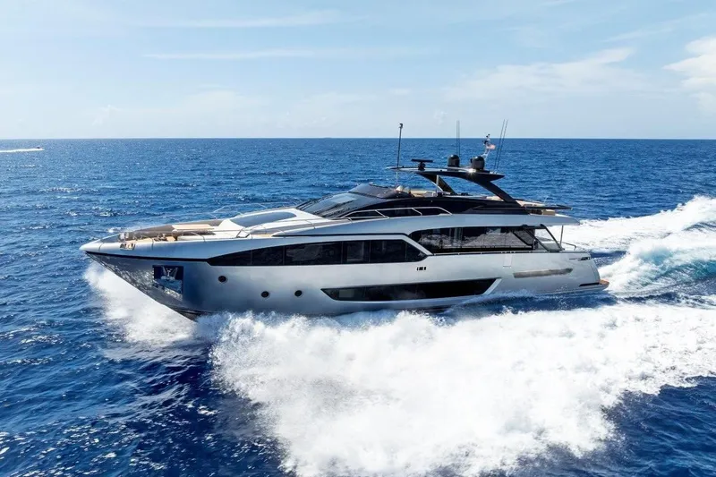 The Image of 2022 Riva 90' Argo yacht cruising on open sea under clear blue sky. - 0