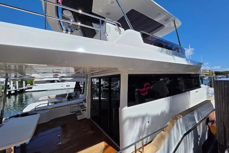 Slide: The Image of 2024 Sirena 58 Flybridge MY yacht docked, showcasing sleek design and spacious deck. - 11