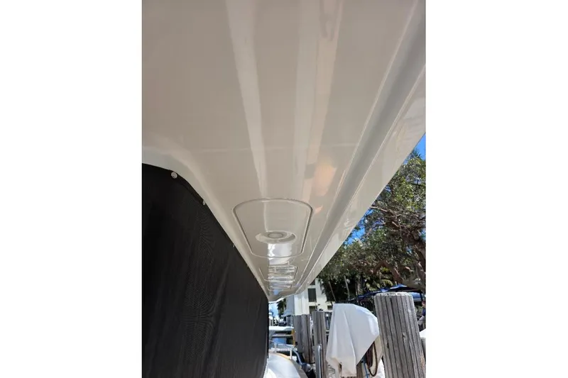 Slide: The Image of 2024 Sirena 58 Flybridge MY yacht detail with sleek white exterior and dockside view. - 21