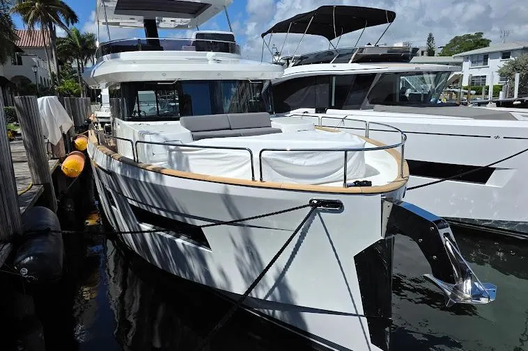 Slide: The Image of 2024 Sirena 58 Flybridge MY yacht docked, showcasing sleek design and modern features. - 3