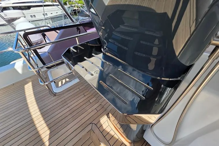 Slide: The Image of 2024 Sirena 58 Flybridge MY yacht deck with sleek design and polished metal railings. - 30