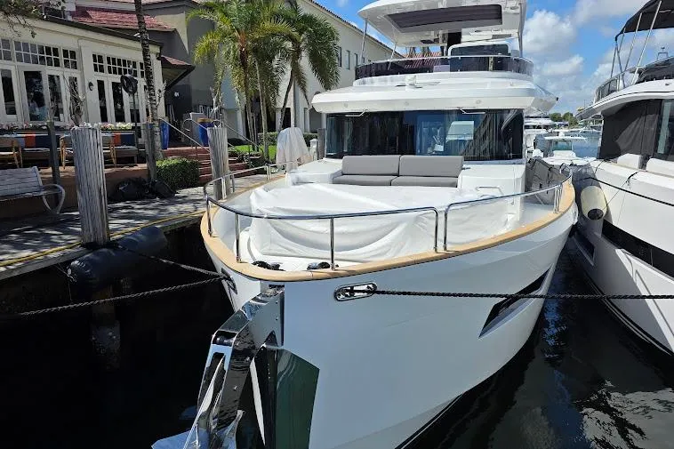 Slide: The Image of 2024 Sirena 58 Flybridge MY yacht docked, showcasing sleek design and luxurious features. - 4