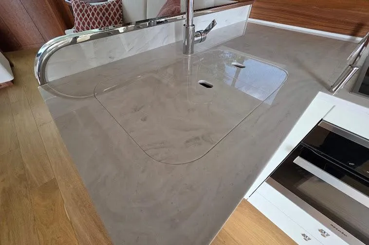 Slide: The Image of Modern kitchen sink area on 2024 Sirena 58 Flybridge yacht, featuring sleek countertop design. - 43