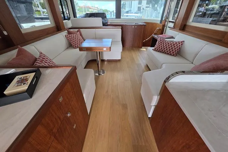 Slide: The Image of Luxurious interior of 2024 Sirena 58 Flybridge MY yacht with elegant seating and wooden flooring. - 51