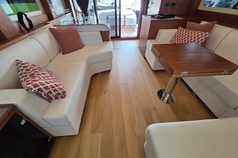 Slide: The Image of Luxurious interior of 2024 Sirena 58 Flybridge MY yacht with elegant seating and wooden flooring. - 54