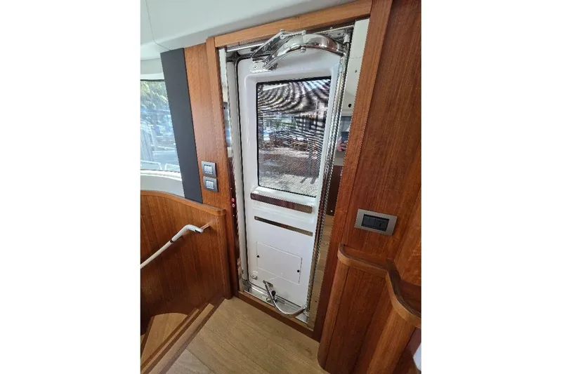 Slide: The Image of Interior view of 2024 Sirena 58 Flybridge MY yacht door with wooden finish. - 56