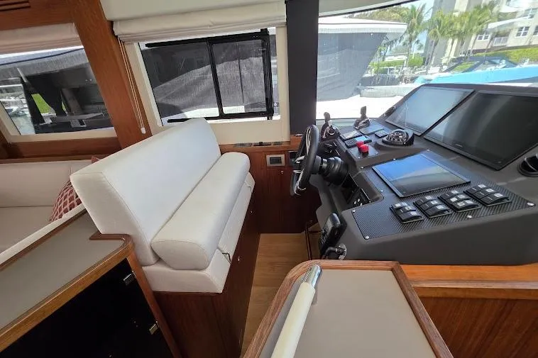 Slide: The Image of 2024 Sirena 58 Flybridge MY helm with modern controls and comfortable seating. - 57