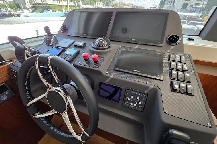 Slide: The Image of Cockpit of 2024 Sirena 58 Flybridge MY with modern navigation controls and steering wheel. - 58