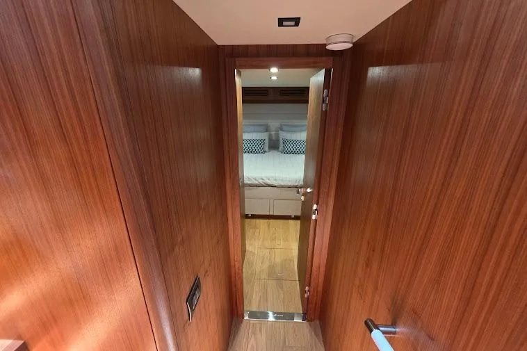 Slide: The Image of Hallway leading to a cozy bedroom in a 2024 Sirena 58 Flybridge MY yacht. - 70