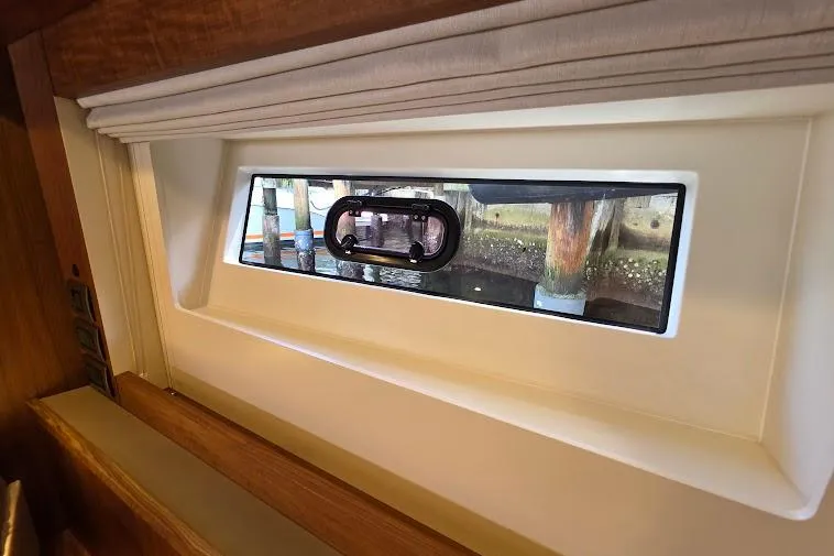 Slide: The Image of Interior view of 2024 Sirena 58 Flybridge MY yacht window with dockside scenery. - 74