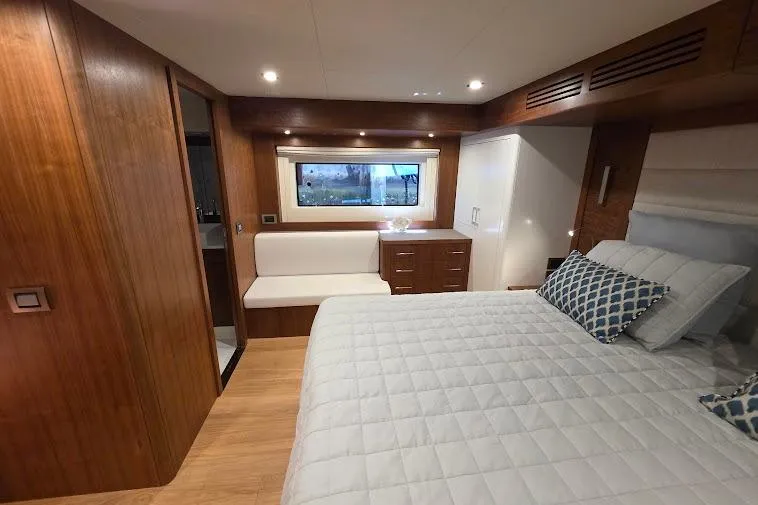 Slide: The Image of Luxurious 2024 Sirena 58 Flybridge MY yacht bedroom with elegant wood finishes and modern decor. - 77