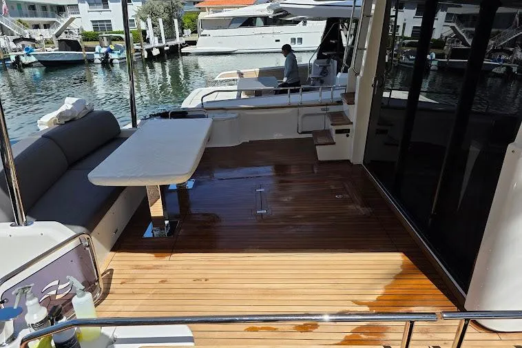 Slide: The Image of 2024 Sirena 58 Flybridge MY yacht with spacious teak deck and seating area. - 8