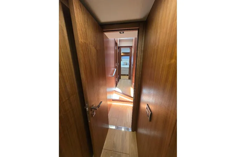 Slide: The Image of Interior hallway of 2024 Sirena 58 Flybridge MY yacht with wooden finish. - 84