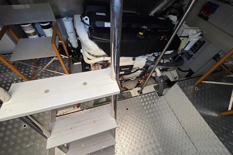 Slide: The Image of Engine room of 2024 Sirena 58 Flybridge MY yacht with visible machinery and metal flooring. - 91