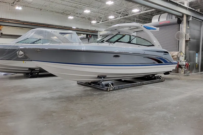 The Image of 2026 Formula 330 Crossover Bowrider I/O in a showroom, showcasing sleek design and modern features. - 1