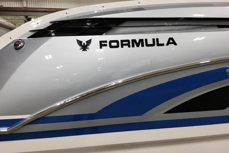 Slide: The Image of 2026 Formula 330 Crossover Bowrider I/O boat with sleek design and logo. - 11