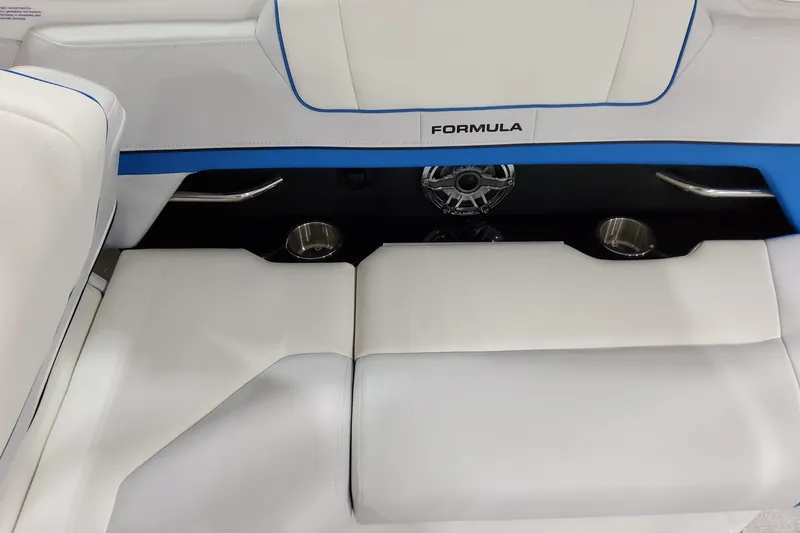 Slide: The Image of 2026 Formula 330 Crossover Bowrider I/O interior with white seating and cup holders. - 12