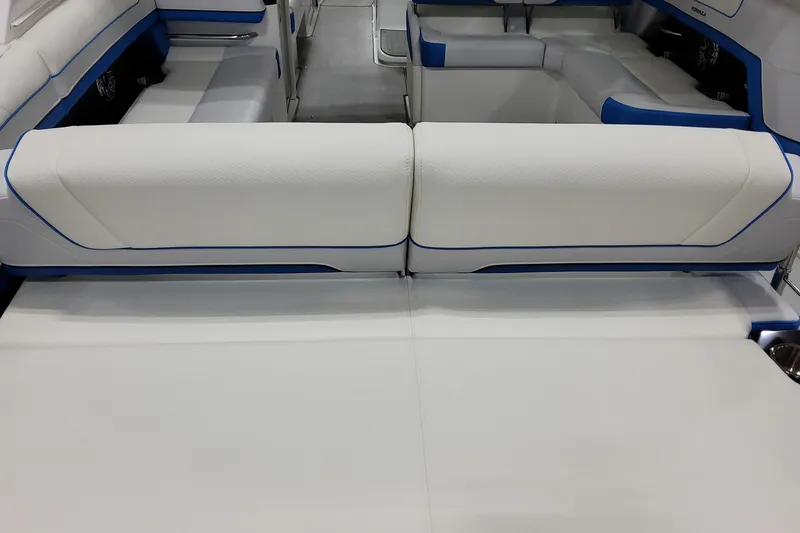 Slide: The Image of 2026 Formula 330 Crossover Bowrider I/O interior with white and blue seating. - 3