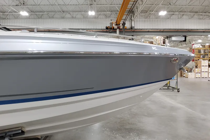 Slide: The Image of 2026 Formula 330 Crossover Bowrider I/O in a warehouse setting. - 6