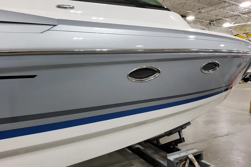 Slide: The Image of 2026 Formula 330 Crossover Bowrider I/O boat side view in a showroom. - 8