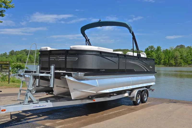 Slide: The Image of 2022 Qwest E822 pontoon boat on trailer by a lake, under clear blue sky. - 10
