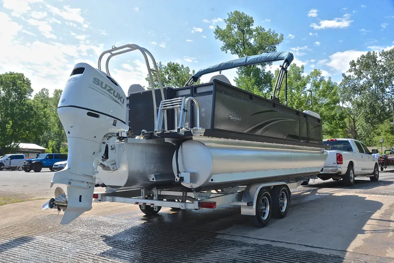 Slide: The Image of 2022 Qwest E822 pontoon boat with Suzuki outboard motor on trailer, ready for launch. - 14