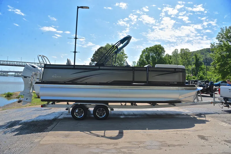 Slide: The Image of 2022 Qwest E822 pontoon boat on trailer by riverside under clear sky. - 15