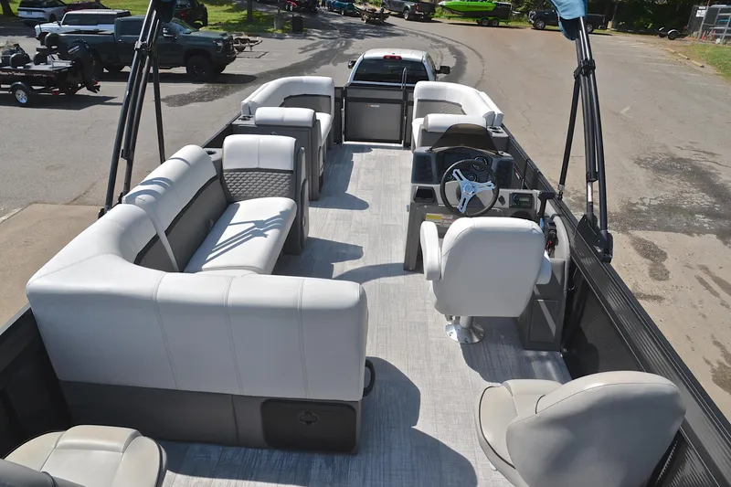 Slide: The Image of Spacious interior of 2022 Qwest E822 pontoon boat with plush seating and modern helm. - 18