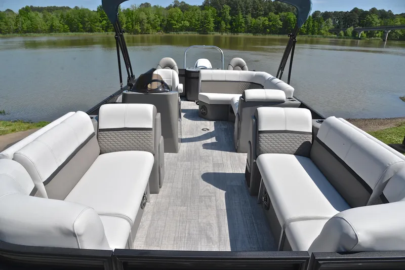 Slide: The Image of Luxurious 2022 Qwest E822 pontoon boat interior with plush seating by a serene lake. - 20