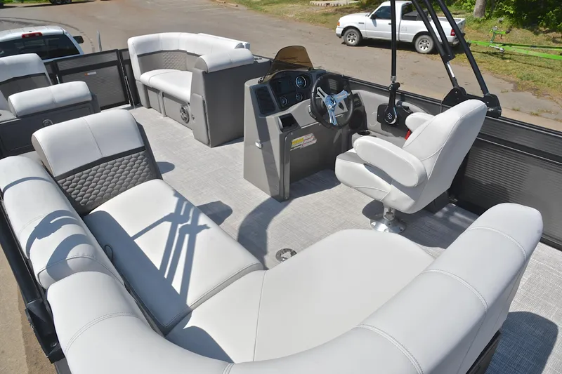 Slide: The Image of Luxurious 2022 Qwest E822 pontoon boat interior with plush seating and modern helm. - 25