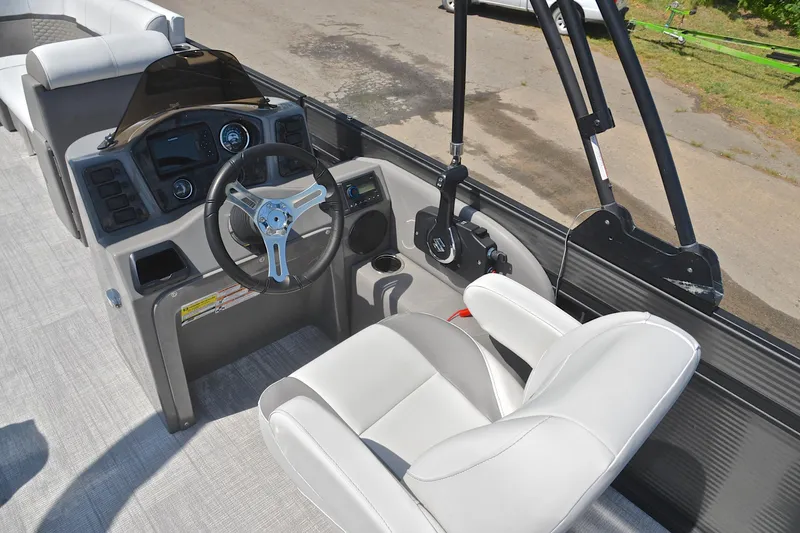 Slide: The Image of 2022 Qwest E822 boat interior with steering wheel and captain's chair. - 26