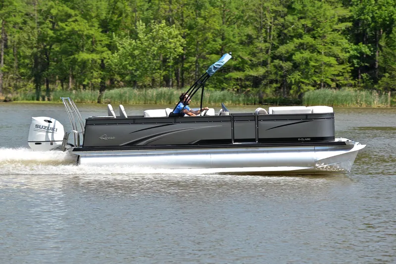 Slide: The Image of 2022 Qwest E822 pontoon boat cruising on a lake with lush green trees. - 3
