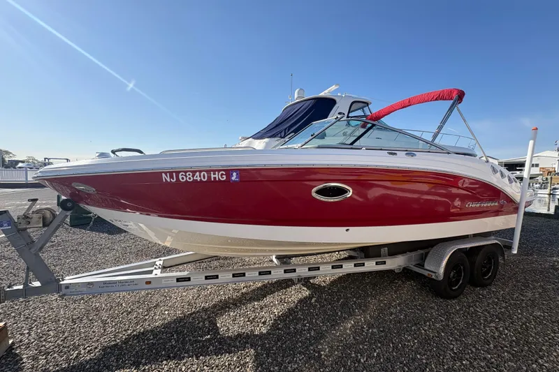 The Image of 2015 Chaparral 246 SSi boat on trailer, red and white exterior, sunny day. - 0
