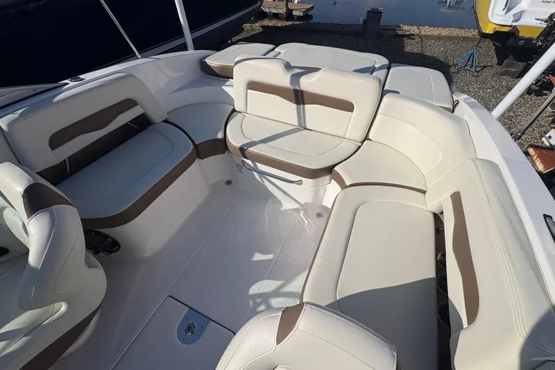 Slide: The Image of 2015 Chaparral 246 SSi boat interior with beige and brown seating arrangement. - 10