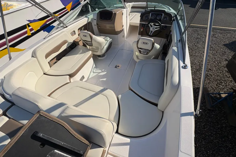 Slide: The Image of 2015 Chaparral 246 SSi boat interior with white seating and modern dashboard. - 11