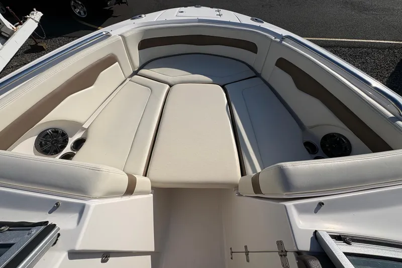 Slide: The Image of 2015 Chaparral 246 SSi boat interior with beige seating and built-in speakers. - 13