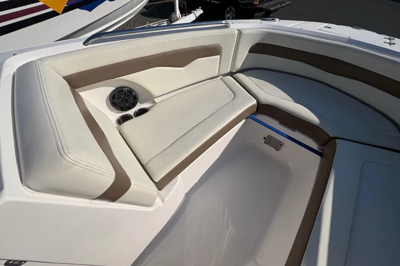 Slide: The Image of 2015 Chaparral 246 SSi boat interior with beige seating and cup holders. - 15