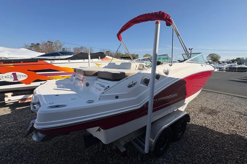 Slide: The Image of 2015 Chaparral 246 SSi boat with red and white exterior on a trailer. - 3