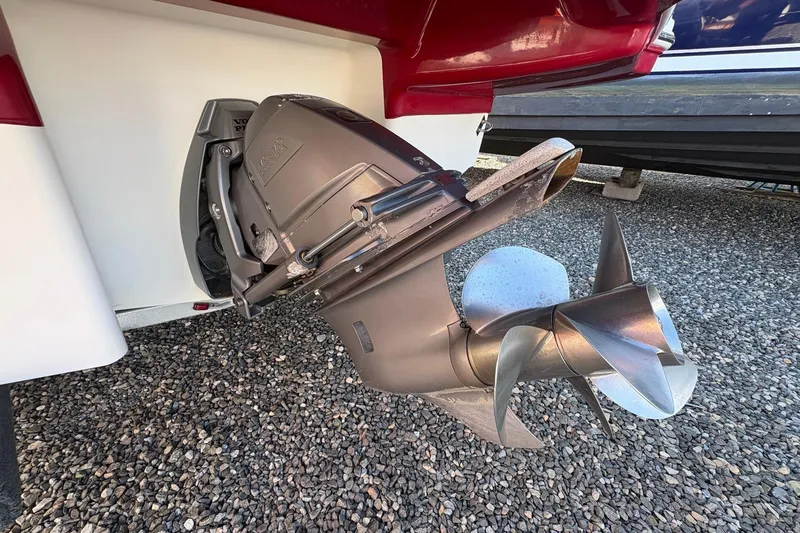 Slide: The Image of 2015 Chaparral 246 SSi boat propeller and outdrive on gravel surface. - 5