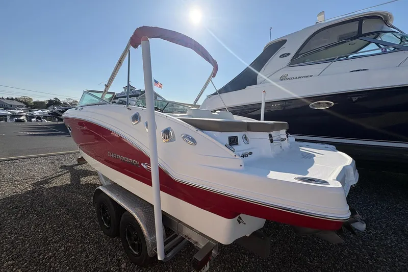 Slide: The Image of 2015 Chaparral 246 SSi boat with red and white exterior on a trailer. - 6