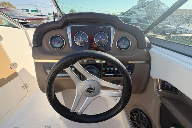 Slide: The Image of Steering wheel and dashboard of a 2015 Chaparral 246 SSi boat. - 7